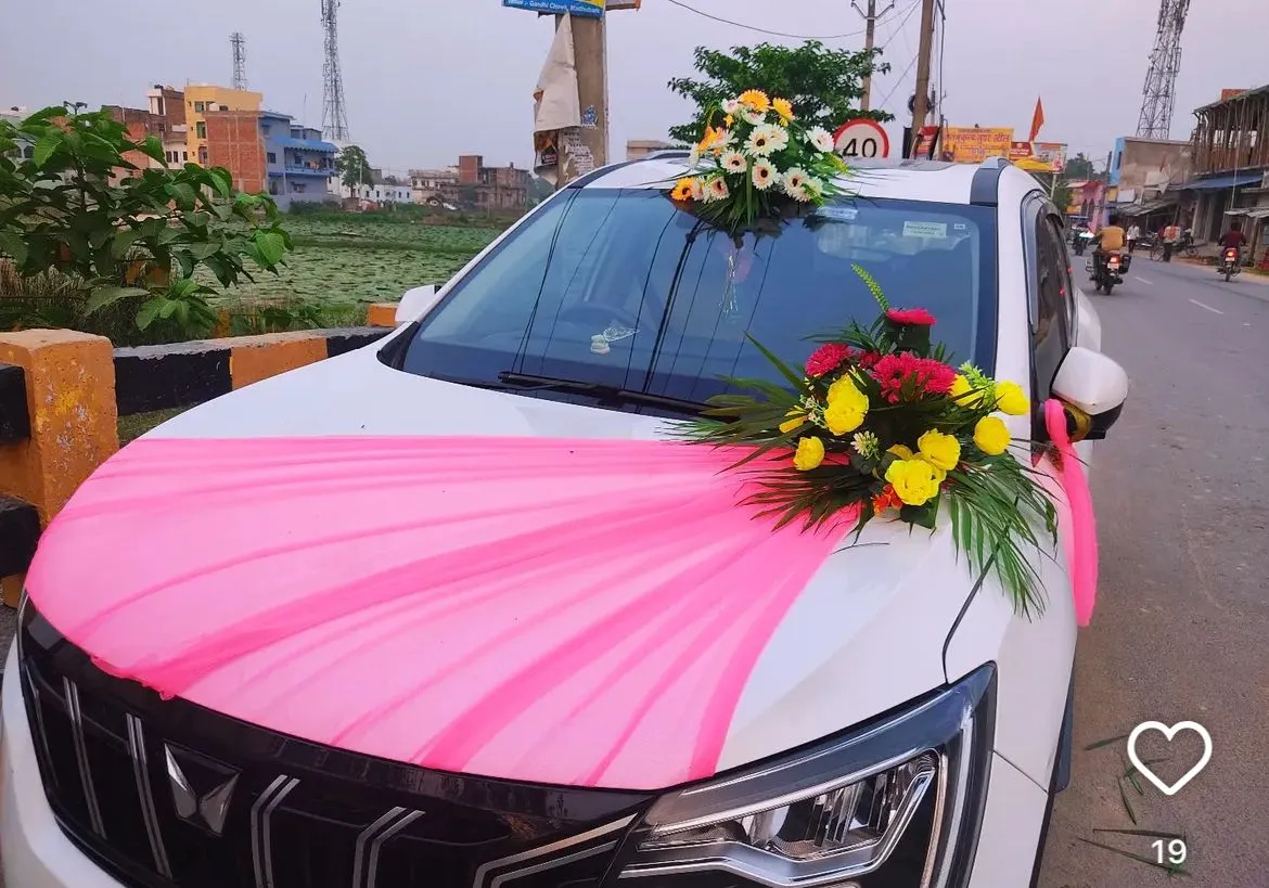 White SUV with pink ribbon and flower top decoration